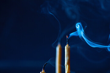 Smoke from an extinguished candle on a dark background.