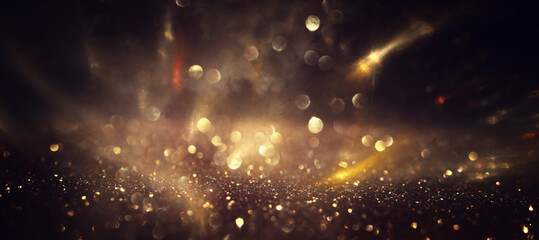 background of abstract gold and black glitter lights. defocused