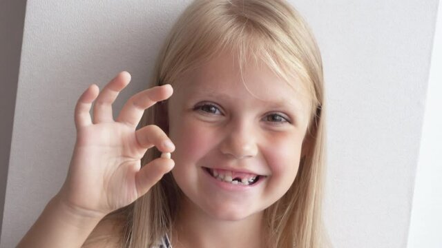 Little cute child girl portrait smile without one front milk tooth