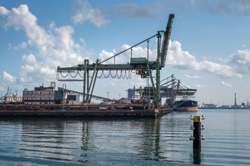 Fototapeta na wymiar Logistics and transportation of Container Cargo ship and Cargo plane with working crane bridge in shipyard