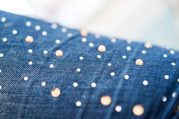 Macro closeup of jeans embellished with shiny rhinestones