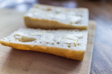 Fototapeta na wymiar Hard butter slices on cut fresh baguette bread