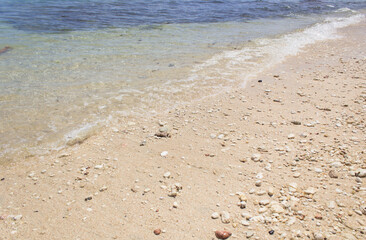 small waves on the beach, with clear water