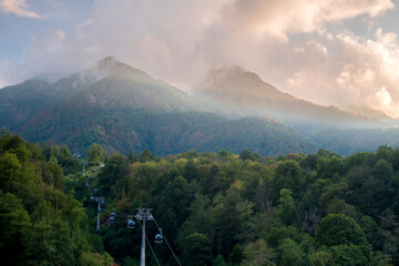 Cable car in the mountains at sunset. Krasnaya Polyana, Sochi, Russia