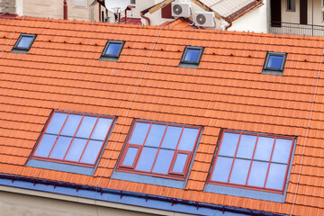 Top view modern orange textured corrugated metal roof with window and air conditioning