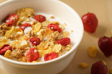 Bowl of Breakfast Cereal with strawberries, almonds and granola 