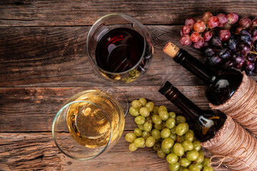 Composition with wine and grapes on wooden background. Wine bottles with grapes, copy space