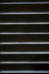 Fototapeta premium Background of an old window with light coming in from outside the blind.