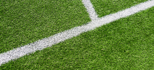 Green artificial grass turf soccer football field background with white lines. Top view