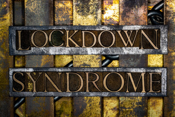 Lockdown Syndrome text formed with real authentic typeset letters on vintage textured silver grunge copper and gold background
