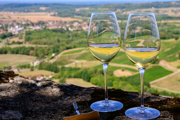 Tasting of white or jaune Jura wine on vineyards near Chateau-Chalon village in Jura region, France