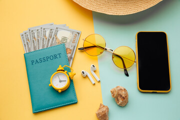 Concept of tourism. Travel accessories and passport with money on yellow blue background.