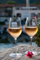 Tasting of local rose wine in summer with sail boats haven of Port Grimaud on background, Provence, France