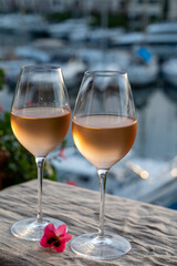 Tasting of local rose wine in summer with sail boats haven of Port Grimaud on background, Provence, France