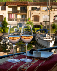 Tasting of local rose wine and soft french goat cheese in summer with sail boats haven of Port...