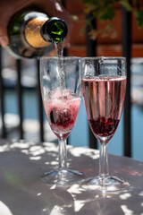 Summer party with sparkling rose champagne wine and sail boats haven of Port Grimaud on background, Provence, France