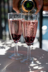 Summer party with sparkling rose champagne wine and sail boats haven of Port Grimaud on background, Provence, France