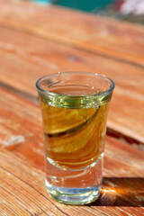 Tasting of very sweet french green strong liqueur based on many herbs, plants and flowers from Chartreuse abbey in Alpine mountains