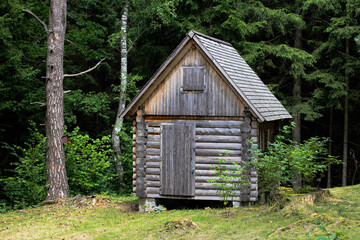 Fototapeta na wymiar Abandoned and locked cabin in the woods