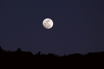 full moon in the night sky at sunset