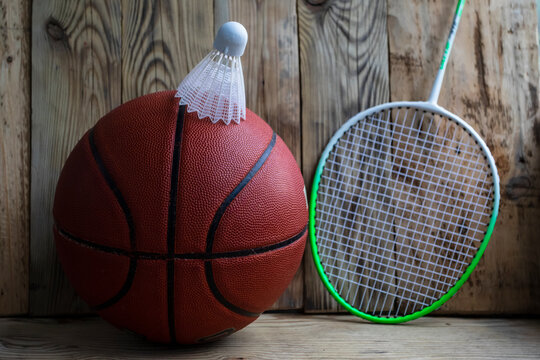 Basketball with a bambinton kit on a vintage wood background.