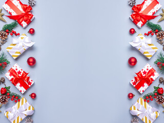 Christmas decoration banner with pine branches, gifts and red berries. Top view. Flat lay.