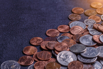 American coins and us dollars on a black table