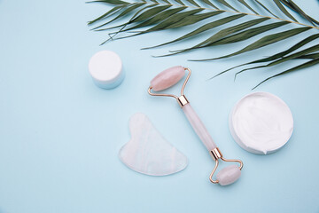 Jade roller and gouache scraper for face massage. Beauty care at home concept.