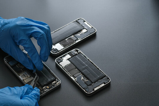 Technician repairing the Cell phone parts and tools for recovery repair phone smartphone and upgrade mobile technology,the concept of computer hardware inside.