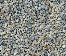 Texture of coloured high-contrast roll gravel, background wallpaper