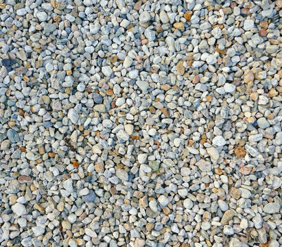 Texture of coloured high-contrast roll gravel, background wallpaper