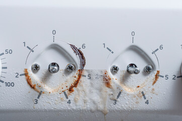 An example of the work of a cleaning service and detailed cleaning of kitchen appliances. Photo of the electric stove switch before and after washing