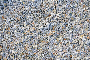 Texture of coloured high-contrast roll gravel, background wallpaper