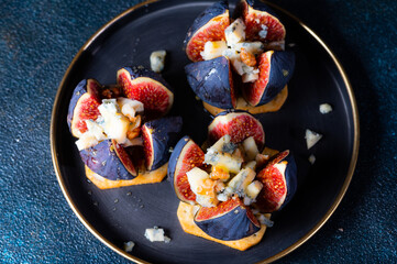 Appetizer with figs and blue cheese. Roquefort cheese. salted cracker. Cheese with honey. Snack and antipasto. Dorblu cheese.