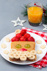 Sandwich with Santa made from toast, peanut butter, strawberry, banana, grape and apple, Christmas menu for kids, vertical, copy space