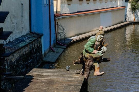 Sculpture of vodyanoy (water demon) near the island of Kampa with the river channel Certovka, Prague, Czech Republic