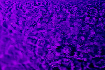 splash of water in lilac light. Abstract wallpaper