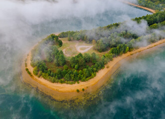 Aerial view of morning autumn fog on the lake.
