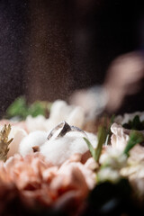 Wedding rings lie on a flower close up