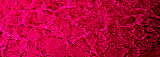 splash of water on a red background. Abstract wallpaper