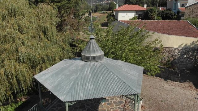 DRONE AERIAL FOOTAGE: Traditional bandstand rotunda with a weathercock on top at large mansion estate near Esposende, Portugal.