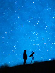 Astronomer observing the immensity of the universe and the stars. Silhouette of a astronomy lover person with a telescope observing the blue starry sky at night.