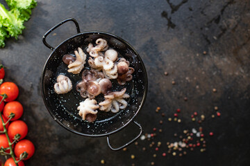 octopus raw seafood fresh baby size on the table serving size top view copy space for text diet pescetarian food background rustic