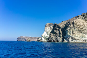Face shaped rock on the blue sea against a blue sky. Akrotiri, santorini, cyclades, Greece