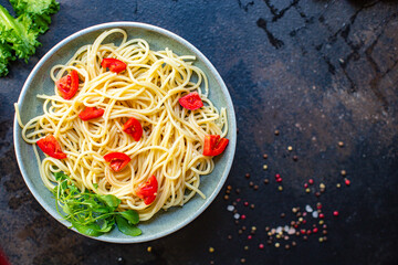 spaghetti pasta tomato warm salad noodles vegetables macaroni semola durum wheat on the table serving size top view place copy space for text food background rustic