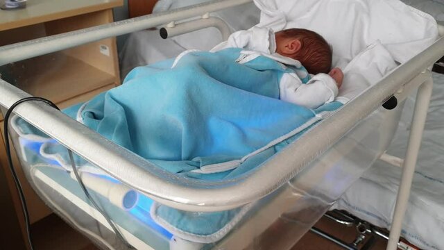 Newborn baby being treated in hospital for newborn jaundice
