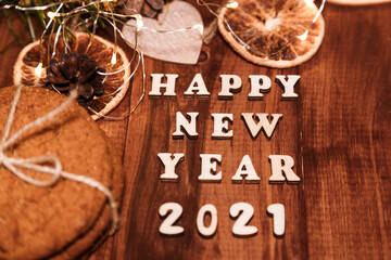 HAPPY NEW YEAR 2021 BACKGROUND OVER DARK STONE TABLE WITH HOLIDAYS DECORATIONS