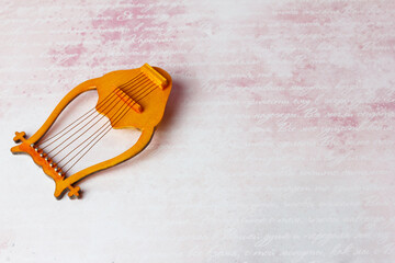 lyre - stringed plucked musical instrument . A symbol of poetry, poetic creativity, and poetic inspiration.