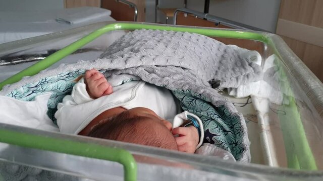 Newborn baby in a hospital bed
