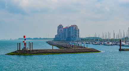 The harbor of Breskens with jetty, boats and big building, Zeeland, The Netherlands